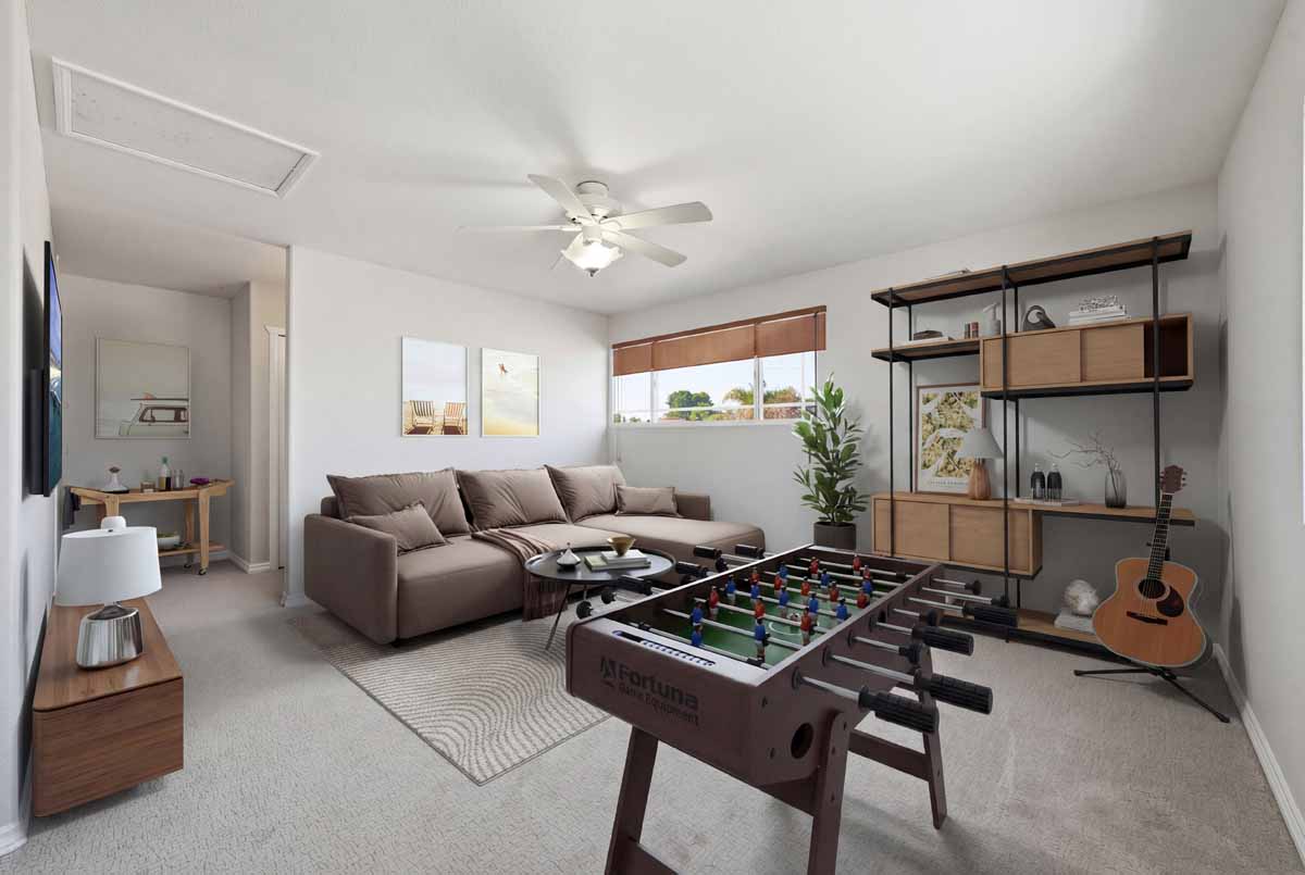 Virtually staged loft with a couch, table, shelves and window.