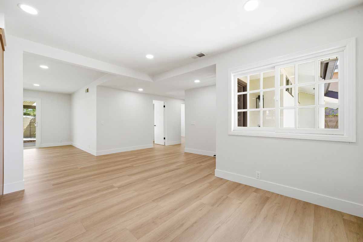 Updated living space with new light-toned wood flooring.