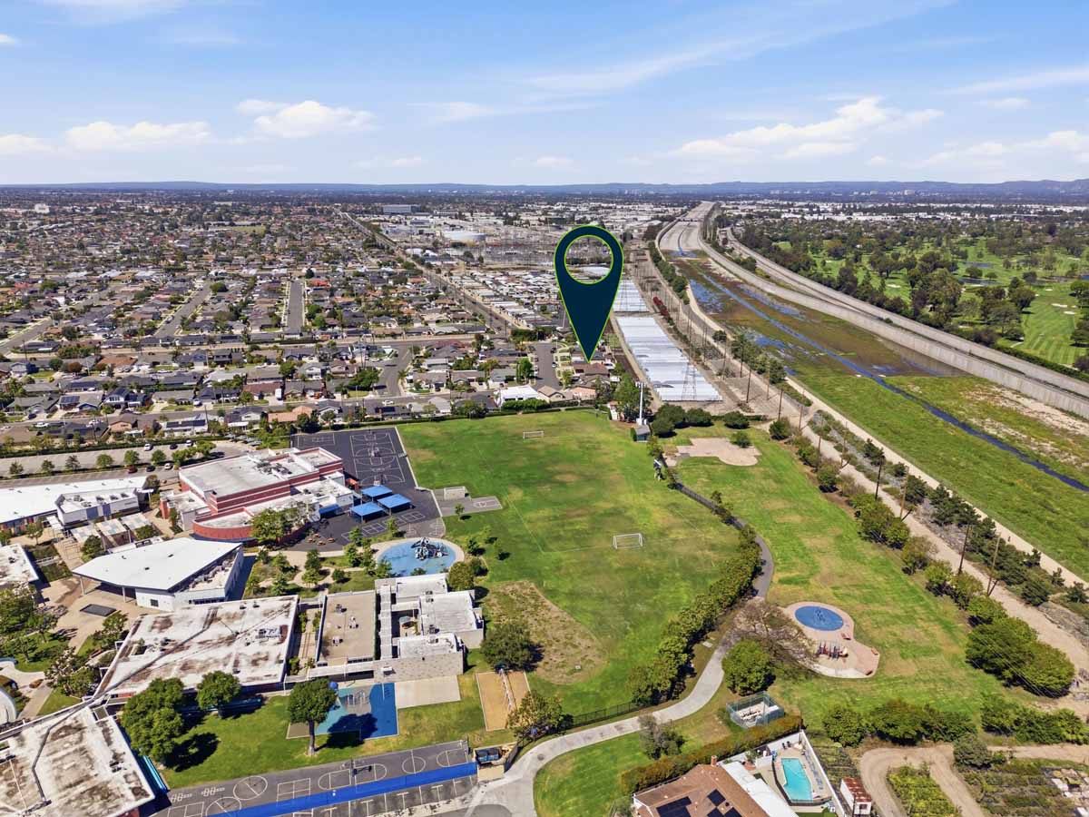 Aerial view of 19562 Aragon Circle, Huntington Beach with an arrow pointing to the house.