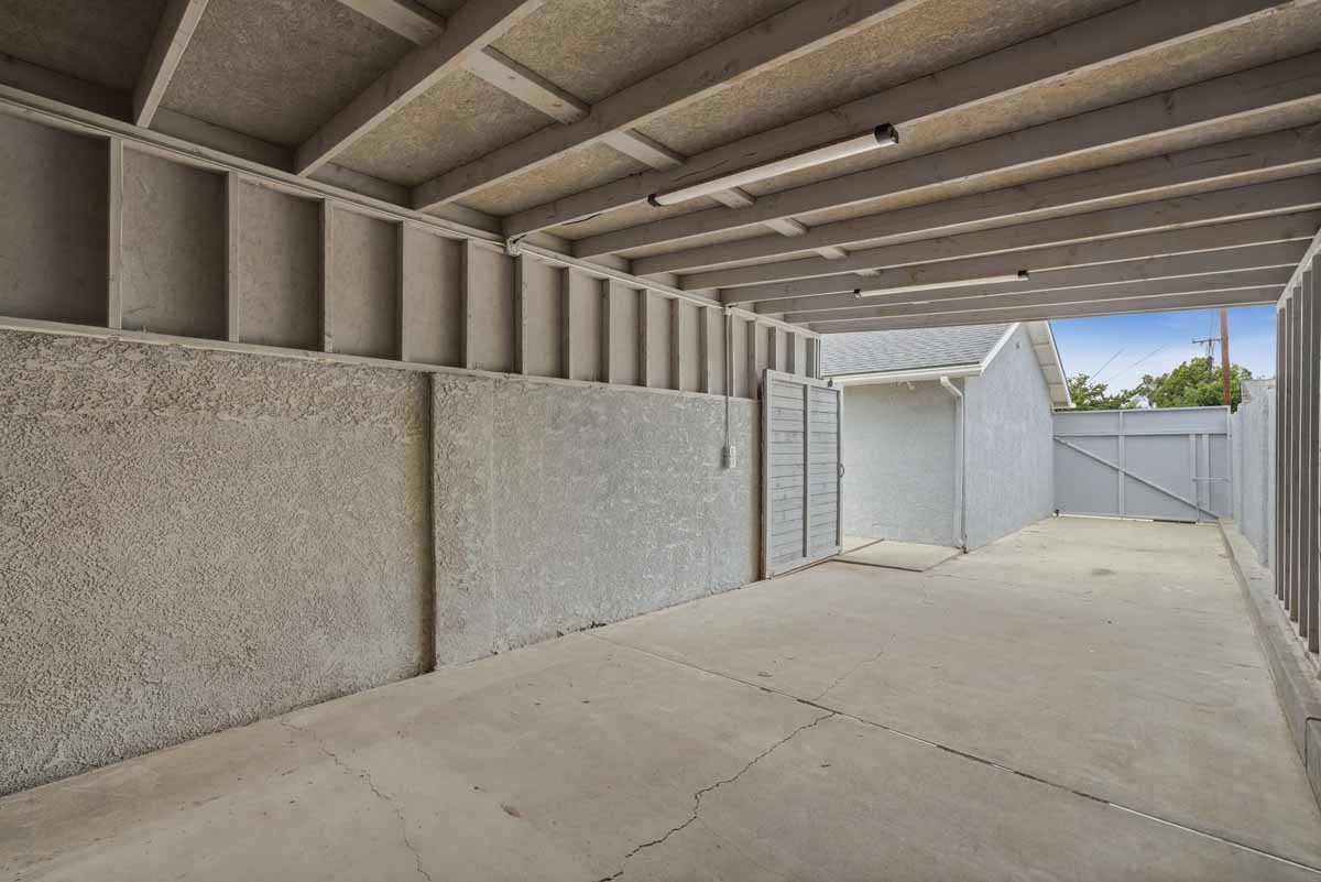 A large covered carport or rv storage space with access to the backyard.