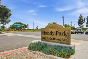 A sign saying Handy Park outside of the park.