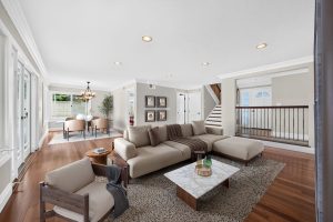 Digitally staged living room with couch and coffee table.