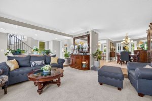 Furnished living room near entry to house.