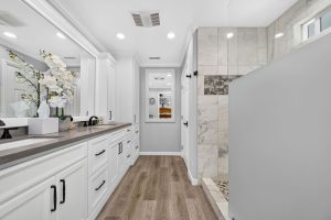 Updated master bedroom with light neutral colors and stone finishes.
