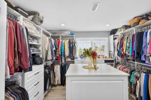 Large walk in closet with a window and center island.