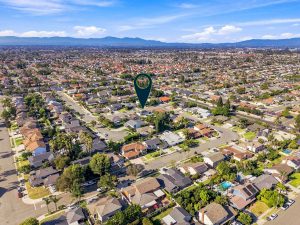 Aerial view of 8938 Martin Avenue, Fountain Valley in a neighborhood with an arrow pointing to house.