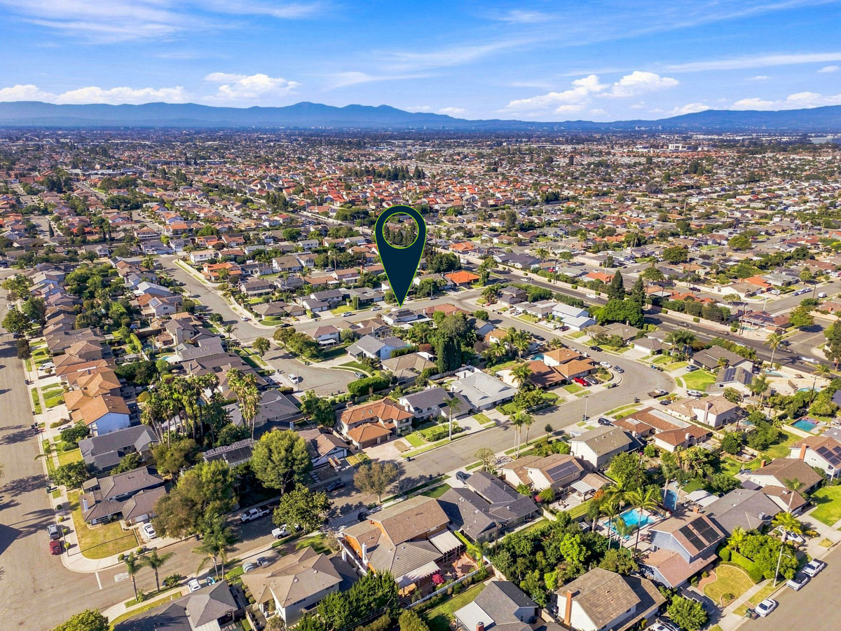 Aerial view of 8938 Martin Avenue, Fountain Valley in a neighborhood with an arrow pointing to house.