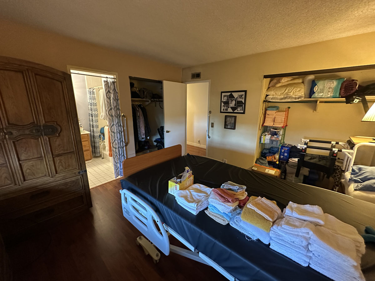 Outdated, dark, cluttered bedroom.