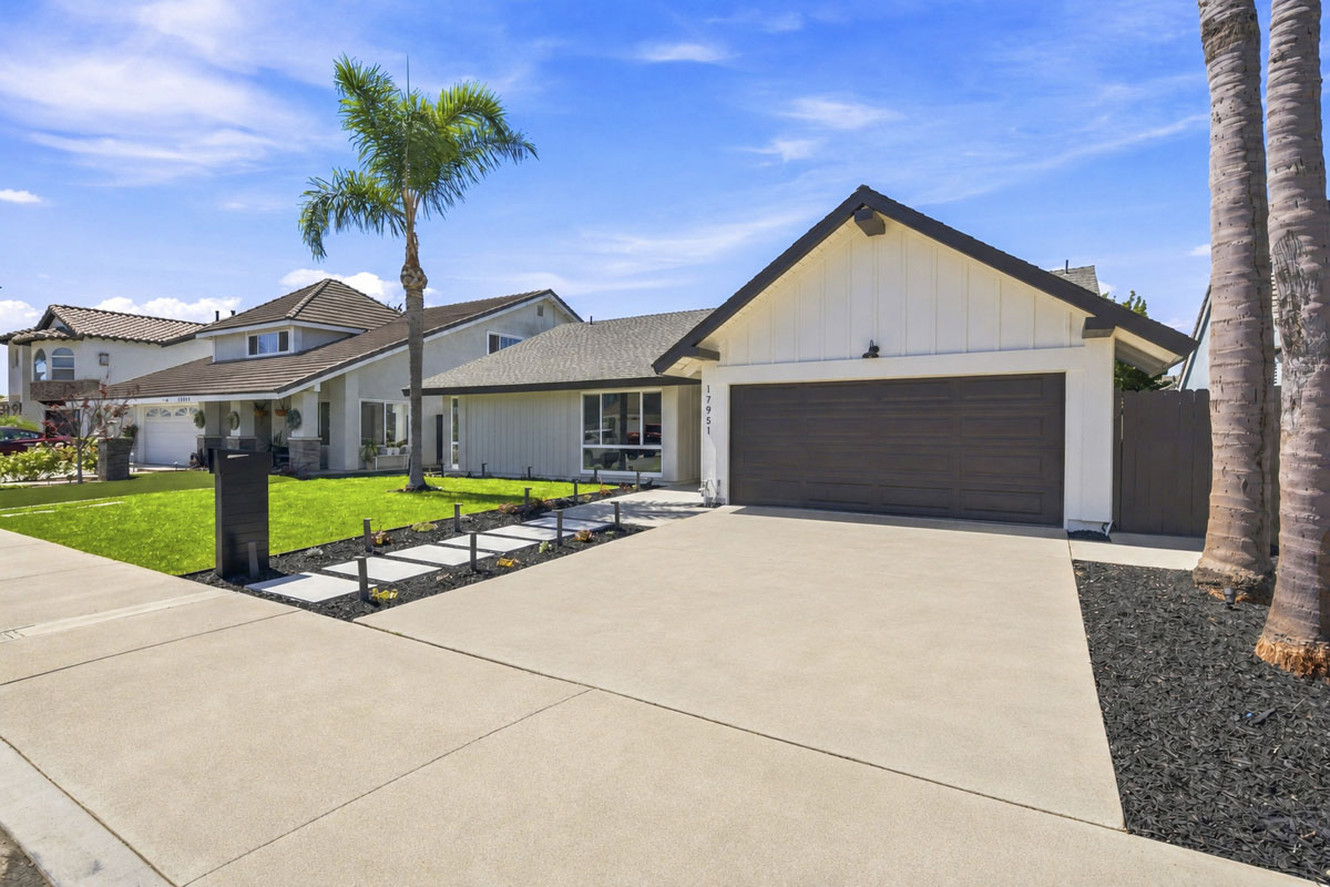 Front of one-story house with white paint and brown painted garage door.