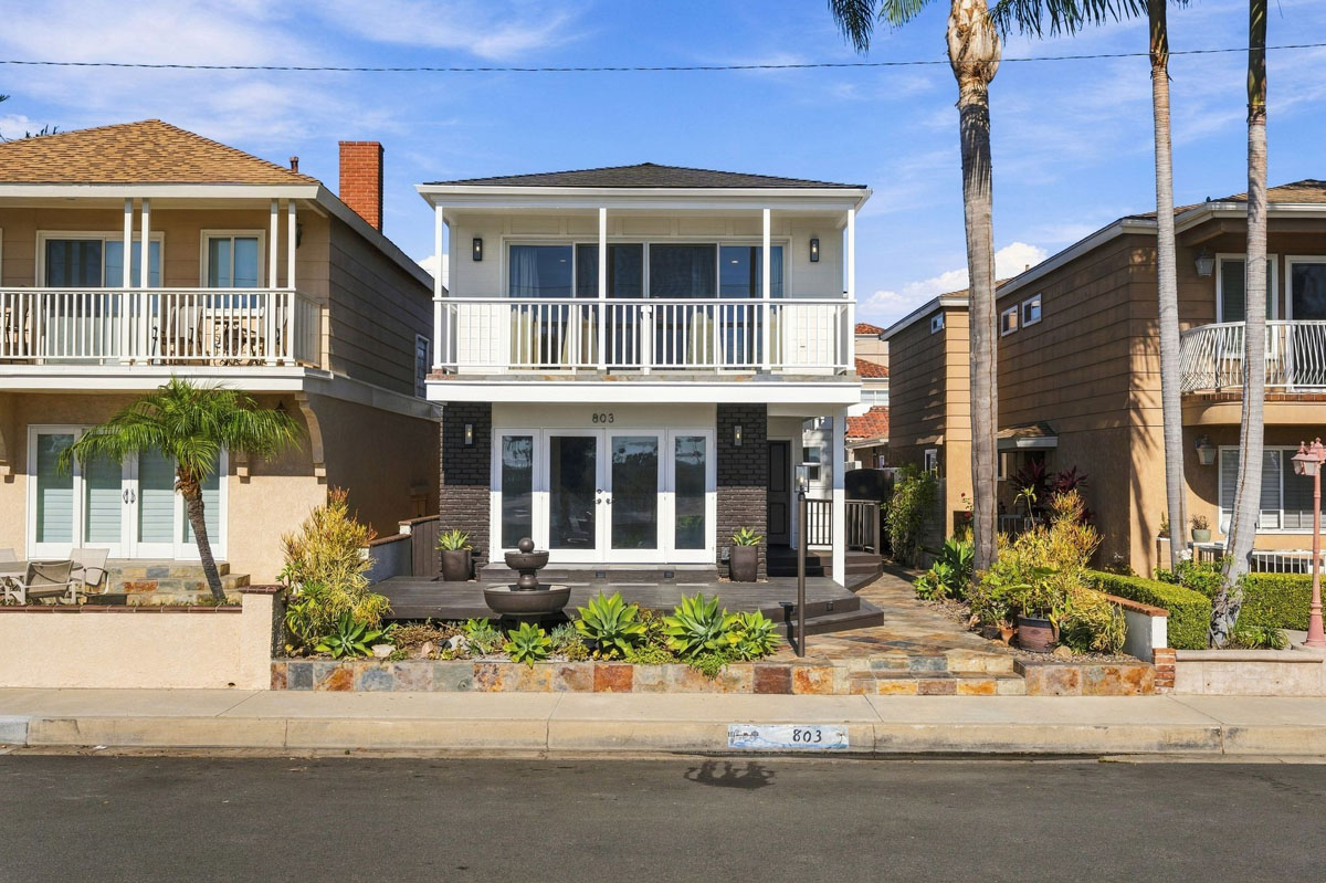 View of the front of 803 Frankfort Avenue, Huntington Beach showing two levels with the second level balcony.