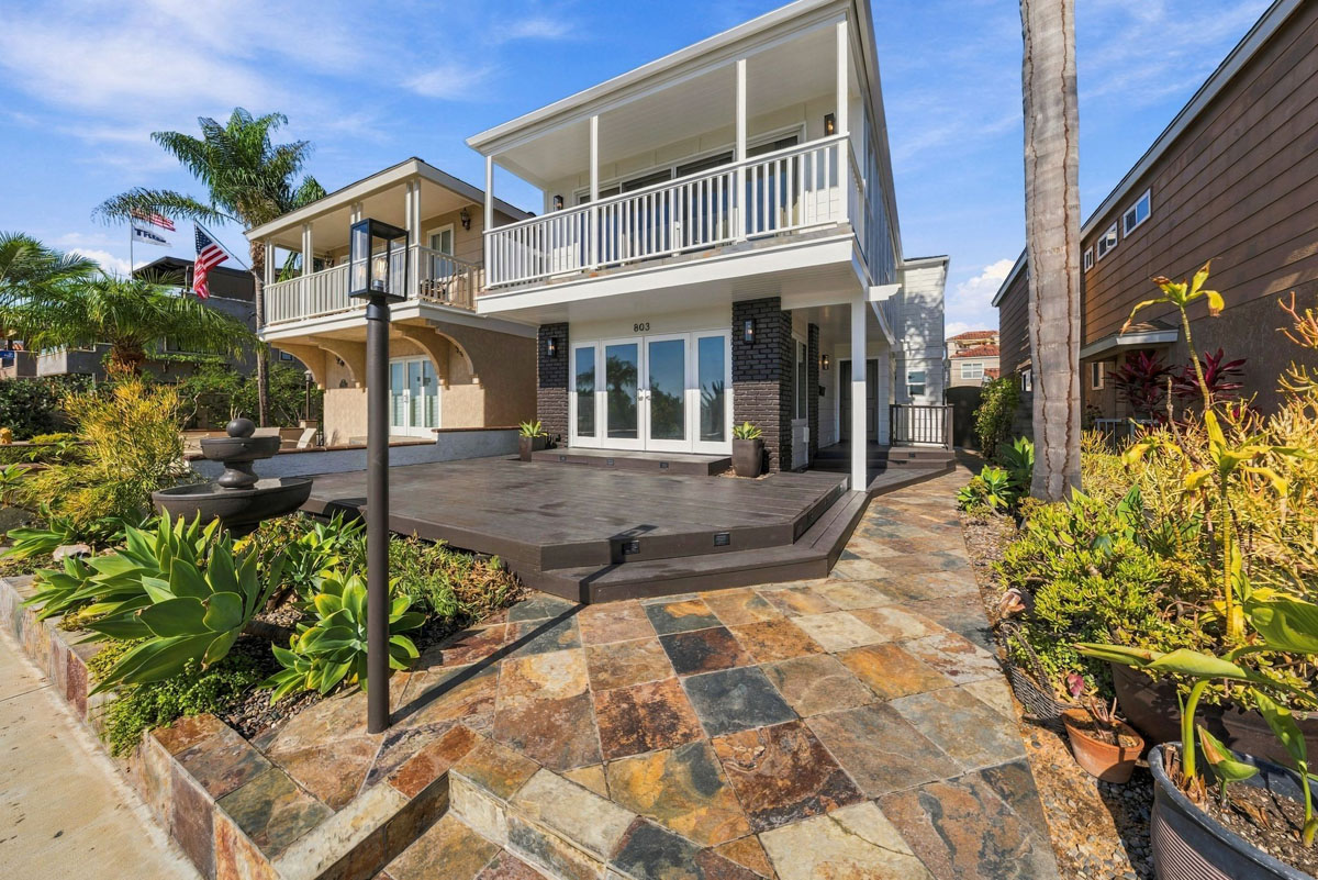 Front of 803 Frankfort Avenue, Huntington Beach with slate tiled walkway leading to dark wood decking.