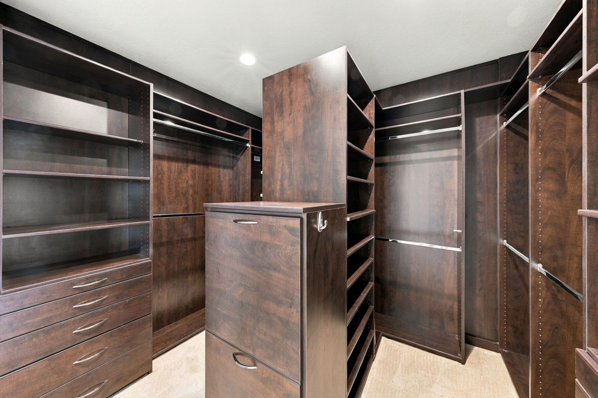 Dark wood built-ins inside the master bedroom closet.